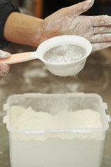 Shifting flour with sieve 