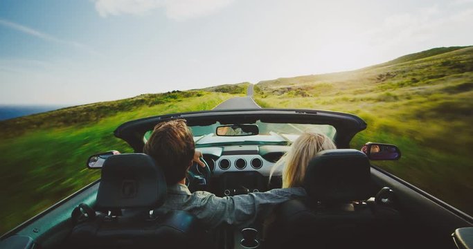 Lifestyle of couple driving on road trip in convertible