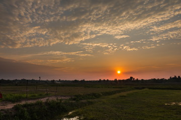 Beautiful sunset over the dark landscape Clouds in the sky and colorful At twilight