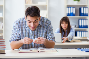 Students sitting and studying in classroom college