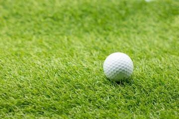 Golf ball is on green grass