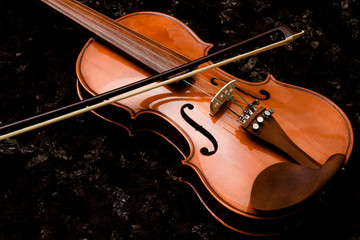 Classic violin and bow on a dark background