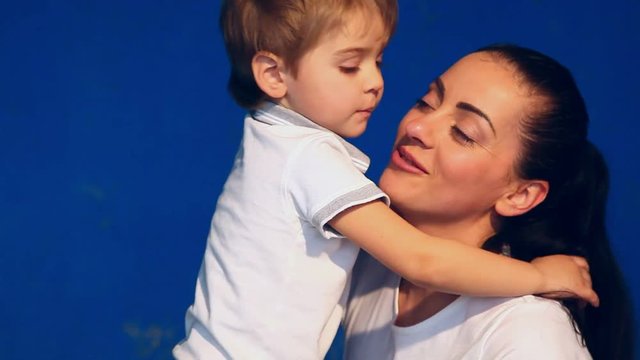 mother and son play laugh and kiss