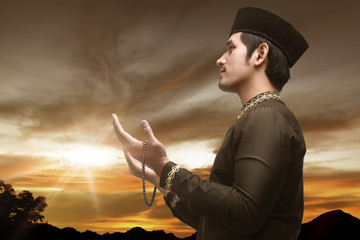 Handsome asian muslim man with prayer beads