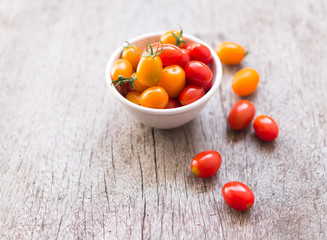 Fresh cherry tomatoes on wood background, raw food and vegetable, selective focus