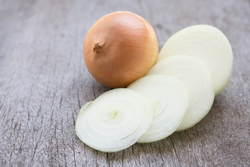 Closeup onion sliced on wood background, food ingredient concept, selective focus