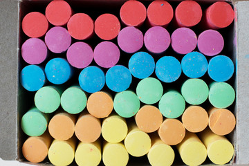 Multi-colored chalk in a cardboard box. Chalk in a box