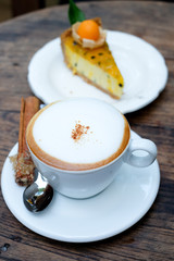 Close up a cup of coffee on wooden table background