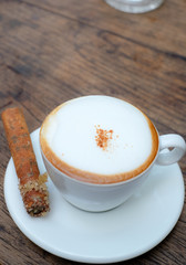 Close up a cup of coffee on wooden table background