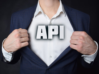 On the businessman's chest is an inscription:API