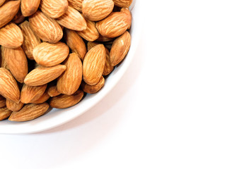 Almond milk in glass with almonds on white background