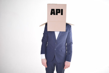 The businessman is holding a box with the inscription:API