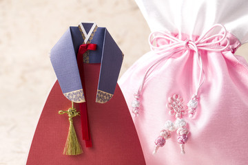 The woman wearing colorful Hanbok, Korean traditional dress isolated on the white background.