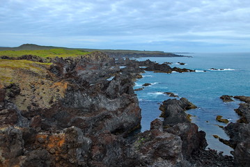 Iceland. The beach with picturesque rocks of petrified lava