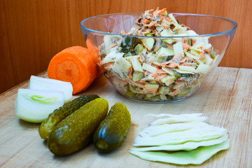 Salad of vitamin cabbage, carrots, onions, pickled cucumber, beef on the wooden. Healthy eating. Homemade.