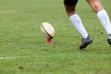 rugby player preparing to kick the oval ball during game © Melinda Nagy