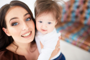 The mother embarcing her daughter and standing in the room
