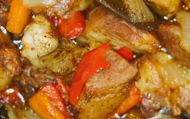 Roast meat, onions, carrots and spices, boiling in oil