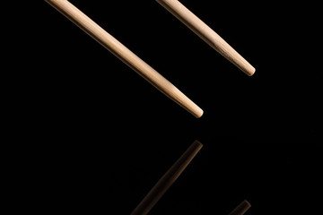 chopsticks on black background. Reflection.