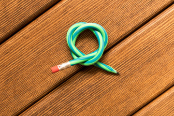  Flexible pencil . Isolated on wooden background