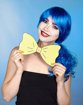 Portrait of young woman in comic  pop art make-up style. Girl with yellow bow-tie in hands