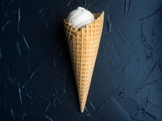 ice cream sugar waffle cones on black coal background, selective focus, space for text.