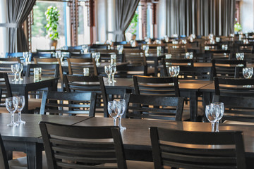 Served desk in a restaurant with muted light ready for the arrival of guests