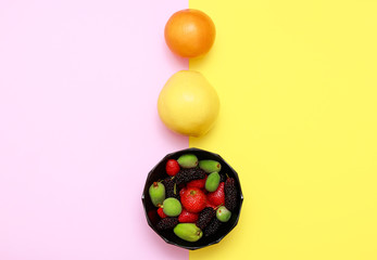 Tasty with summer fruits on a fresh flat lay background. Cherry, blackberry, strawberry, quince, orange. Top flat view