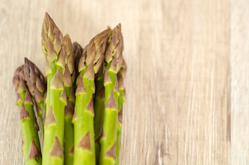 Fresh and green asparagus on the wooden table,