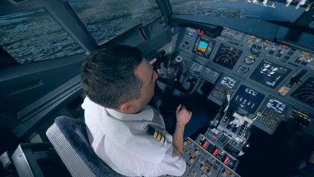The pilot controls the plane in flight simulator.