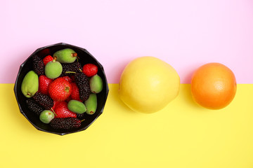 Tasty with summer fruits on a fresh flat lay background. Cherry, blackberry, strawberry, quince, orange. Top flat view