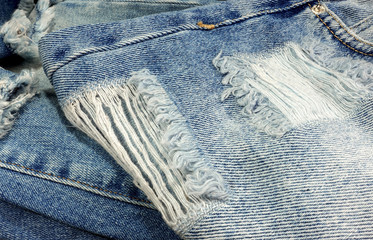 Blue torn jeans close-up.