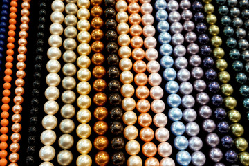 Background of rows of multi-colored beads necklaces