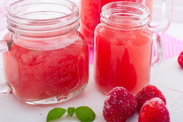 Traditional Russian drink-Kisel (from frozen strawberry) on a white table in glass glasses, horizontal