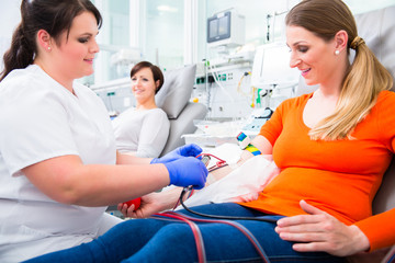 Cheerful nurse disinfecting puncture point before blood donation