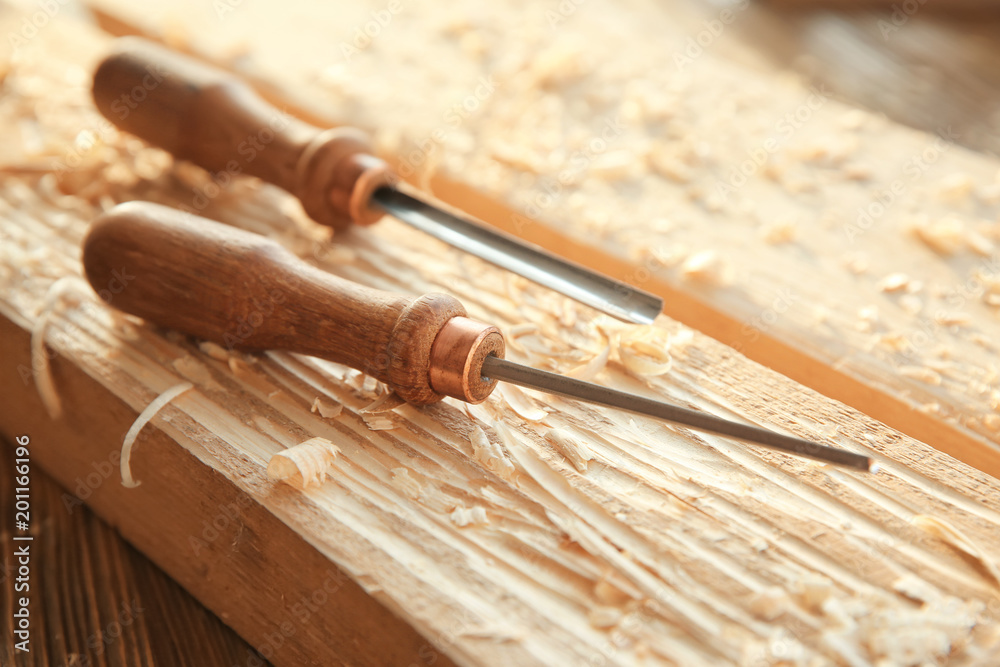 Wall mural chisels, wooden boards and sawdust in carpenter's workshop