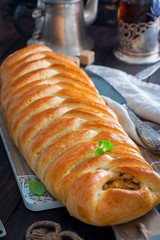 Kulebyaka with cabbage, traditional pie in Russian cuisine, selective focus