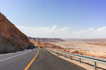 Asphalt road in desert Negev, Israel, road 40, transport infrastructure in desert, scenic mountains route from Eilat to north of Israel