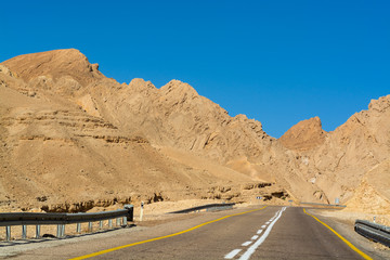 Asphalt road in desert Negev, Israel, road 12, transport infrastructure in desert, scenic mountains route from Eilat to north of Israel