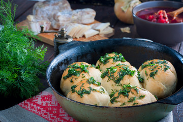 Pampushki with garlic and greens, traditional Ukrainian buns for borsch, selective focus