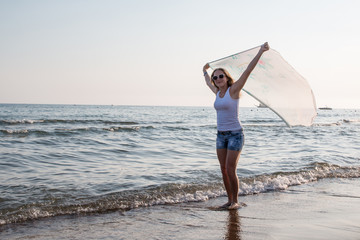 Fototapeta na wymiar Blond teenager girl on the beach near sea