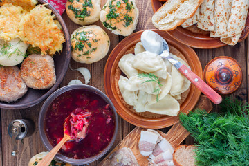 Covered table with traditional Ukrainian food, top view, horizontal