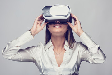 Woman in White Shirt using vr glasses
