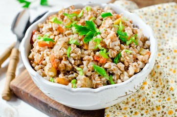 Buckwheat stewed with vegetables: zucchini, carrots, bell peppers, tomatoes and onions