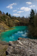 Fototapeta na wymiar Beautiful blue mountain lake. The Blue Colour is caused by former limestone mining. (Blauer See, Hüttenrode near Blankenburg, National Park Harz in Germany