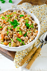 Buckwheat stewed with vegetables: zucchini, carrots, bell peppers, tomatoes and onions