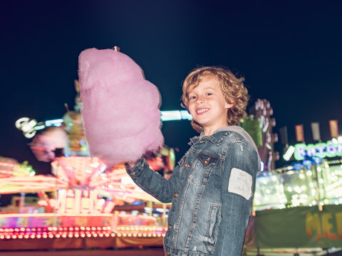 Cheerful boy with pink candy floss