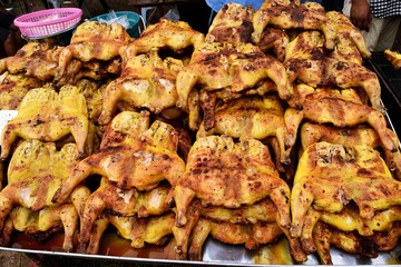 Grilled Chicken with yellow spice  , Thai Muslims food,Many roast chickens in a tray 
