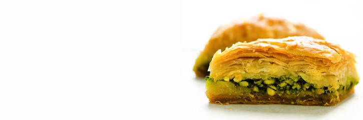 Middle eastern dessert baklava on white background. Free space for your text. Banner.