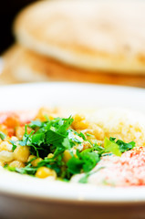 Classic hummus with parsley and pita. Traditional jewish food and middle eastern cuisine recipe.